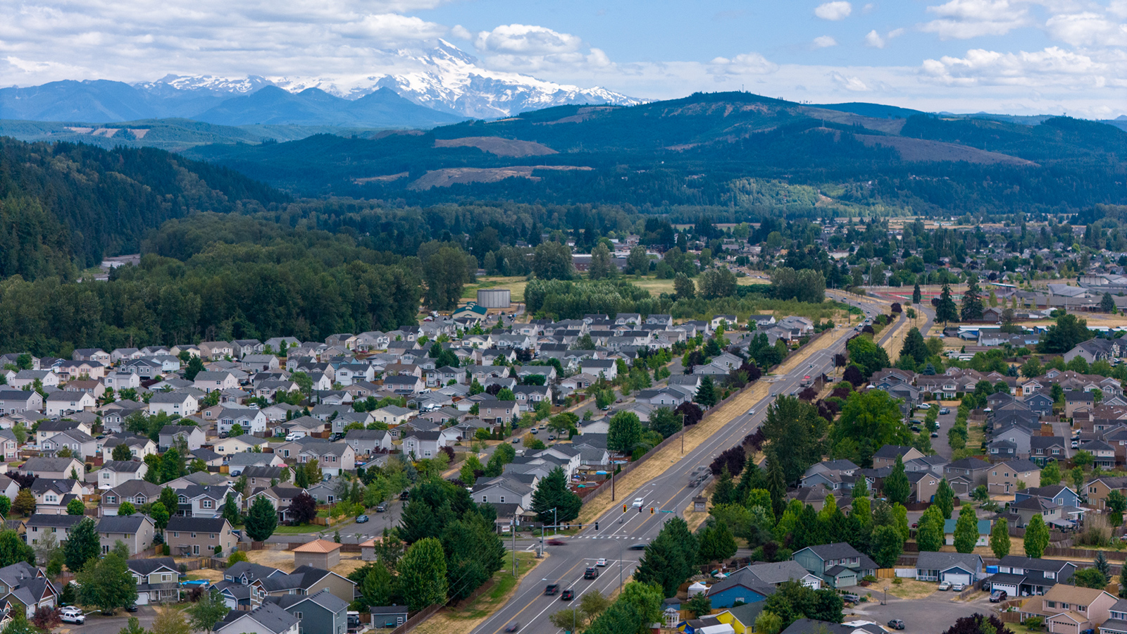 Aerial photo of SR 162 looking southeast in Orting. Mount Rainier is in the background, with neighborhoods on both sides of SR 162