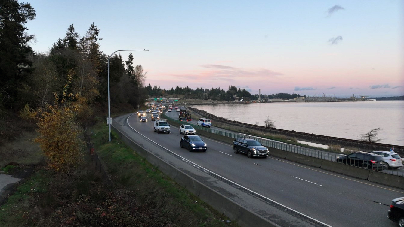 Photo of cards driving on SR 3 at dusk. The study area experiences regular congestion due to lack of capacity and multimodal options.